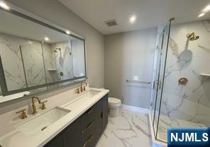 25 Division St Unit 403, Cresskill, NJ 07626 - full bath featuring marble finish flooring, a marble finish shower, double vanity, and recessed lighting