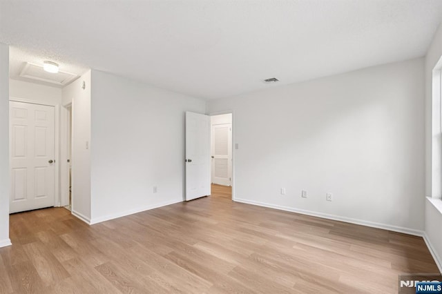 7 Eakens Ct, Mahwah, NJ 07430 - empty room featuring light wood-style flooring and attic access