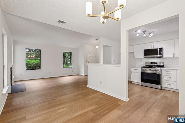 7 Eakens Ct, Mahwah, NJ 07430 - kitchen featuring stainless steel appliances, a chandelier, light wood finished floors, light countertops, and white cabinets