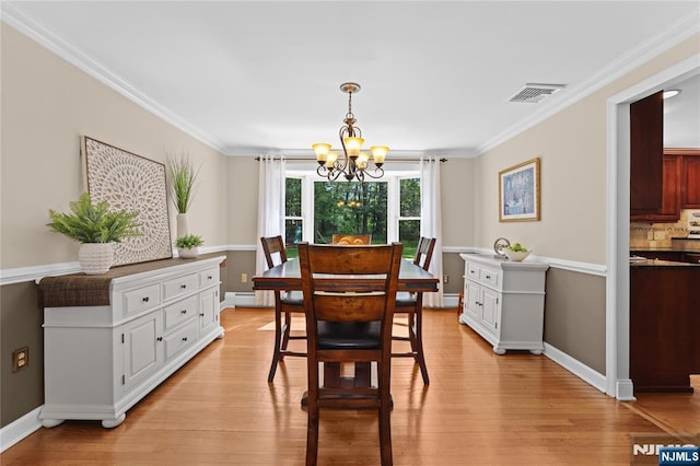 8 Fieldstone Dr, Kinnelon Borough, NJ 07405 - dining space with a chandelier, light wood-style floors, a baseboard heating unit, and crown molding