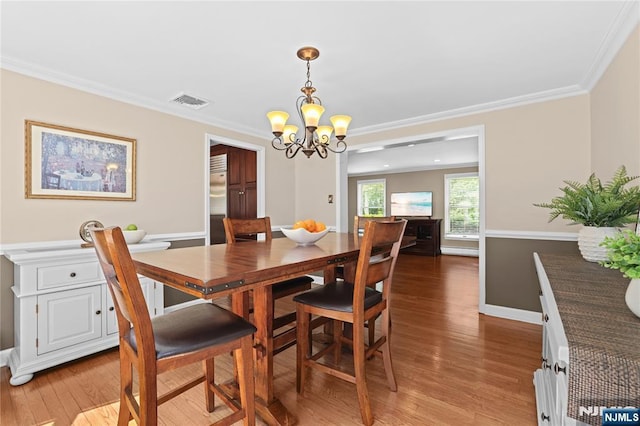 8 Fieldstone Dr, Kinnelon Borough, NJ 07405 - dining space featuring a chandelier, light wood finished floors, and crown molding