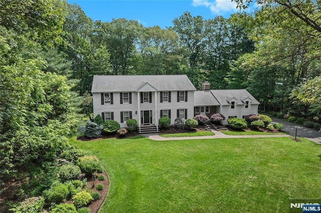 8 Fieldstone Dr, Kinnelon Borough, NJ 07405 - colonial inspired home featuring a front yard and a chimney