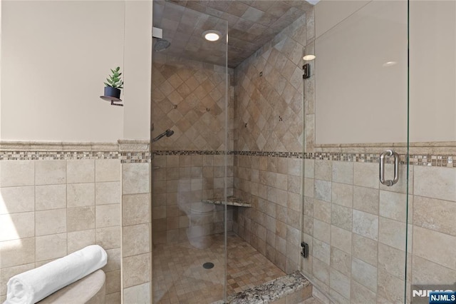 8 Fieldstone Dr, Kinnelon Borough, NJ 07405 - bathroom with a shower stall, tile walls, and a wainscoted wall