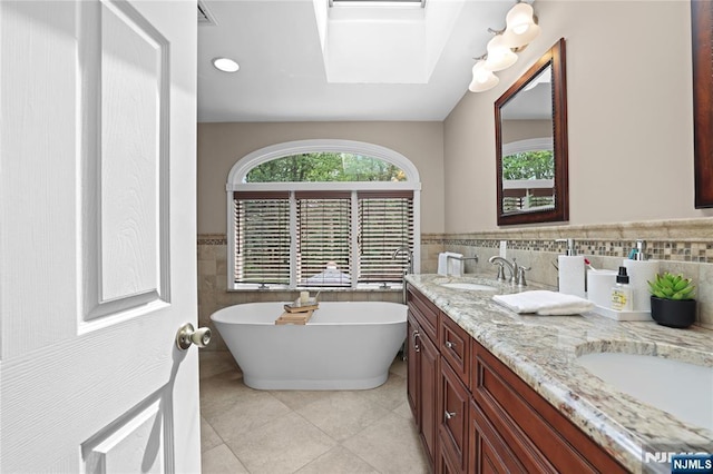 8 Fieldstone Dr, Kinnelon Borough, NJ 07405 - bathroom with tile patterned flooring, a soaking tub, double vanity, tile walls, and wainscoting