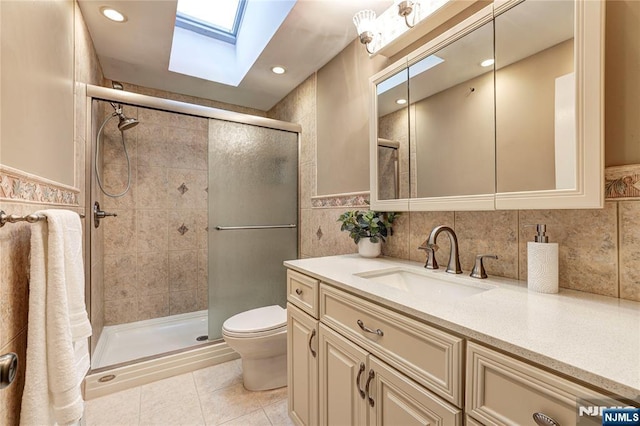 8 Fieldstone Dr, Kinnelon Borough, NJ 07405 - bathroom with a skylight, tile walls, vanity, a shower stall, and tile patterned flooring