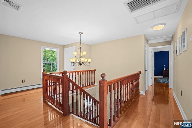 8 Fieldstone Dr, Kinnelon Borough, NJ 07405 - hall with an upstairs landing, a baseboard heating unit, and hardwood / wood-style floors