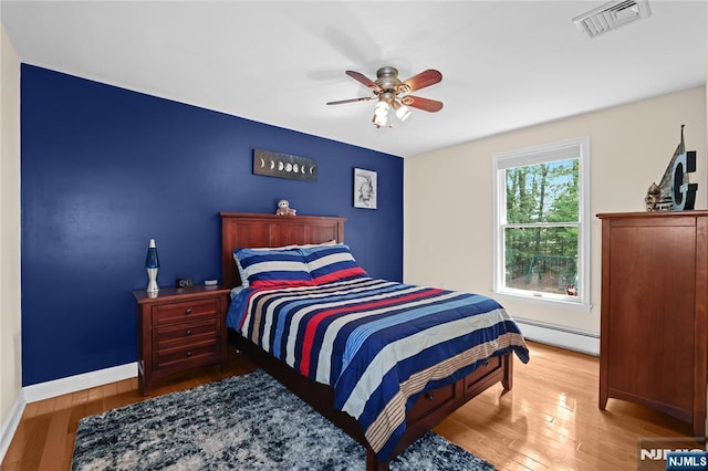 8 Fieldstone Dr, Kinnelon Borough, NJ 07405 - bedroom with a baseboard radiator, wood finished floors, and a ceiling fan