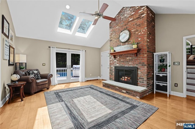8 Fieldstone Dr, Kinnelon Borough, NJ 07405 - living room featuring high vaulted ceiling, ceiling fan, wood finished floors, a brick fireplace, and french doors
