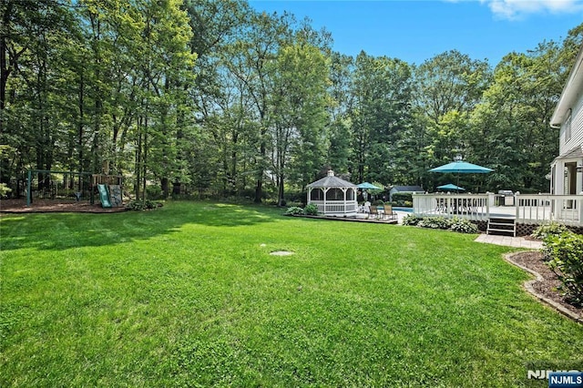 8 Fieldstone Dr, Kinnelon Borough, NJ 07405 - view of grassy yard featuring a gazebo, a deck, and a playground