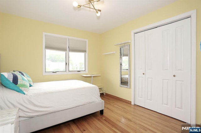 39-23 Pershing St, Fair Lawn, NJ 07410 - bedroom featuring a closet, light wood-style floors, and a chandelier