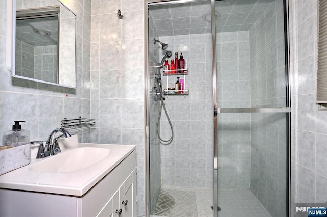 39-23 Pershing St, Fair Lawn, NJ 07410 - full bathroom featuring vanity, a shower stall, and tile walls