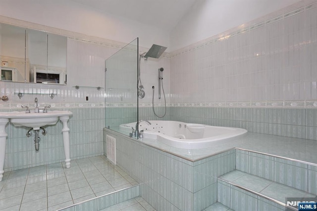 39-23 Pershing St, Fair Lawn, NJ 07410 - bathroom with tile walls, tile patterned floors, vaulted ceiling, and a combined bath / shower with jetted tub