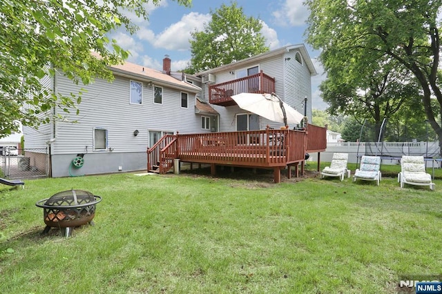 39-23 Pershing St, Fair Lawn, NJ 07410 - back of house with a fire pit, a balcony, a deck, and a trampoline
