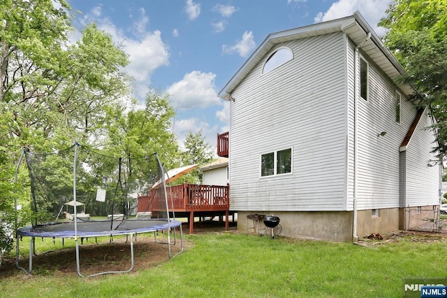 39-23 Pershing St, Fair Lawn, NJ 07410 - rear view of property featuring a trampoline, a deck, and a lawn