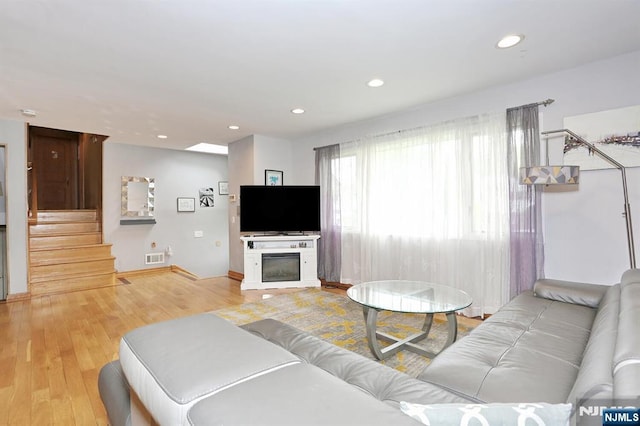39-23 Pershing St, Fair Lawn, NJ 07410 - living room with stairway, wood finished floors, and recessed lighting