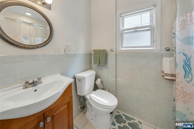 116 Berkeley Ave, Bloomfield, NJ 07003 - full bathroom featuring tile walls, vanity, wainscoting, tile patterned floors, and curtained shower