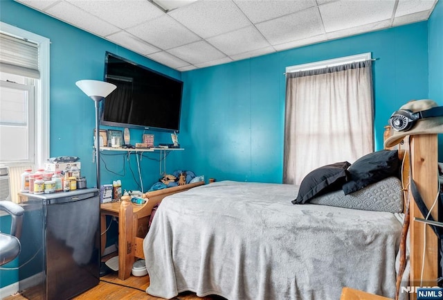 116 Berkeley Ave, Bloomfield, NJ 07003 - bedroom featuring fridge, wood finished floors, and a drop ceiling