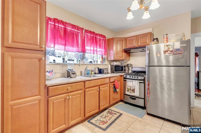 116 Berkeley Ave, Bloomfield, NJ 07003 - kitchen with appliances with stainless steel finishes, light tile patterned flooring, under cabinet range hood, light countertops, and a chandelier