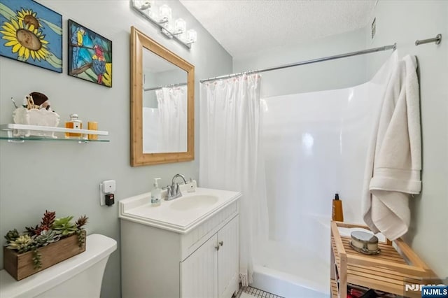 555 N Ave Unit 23C, Fort Lee, NJ 07024 - bathroom featuring vanity, a textured ceiling, and a shower with shower curtain