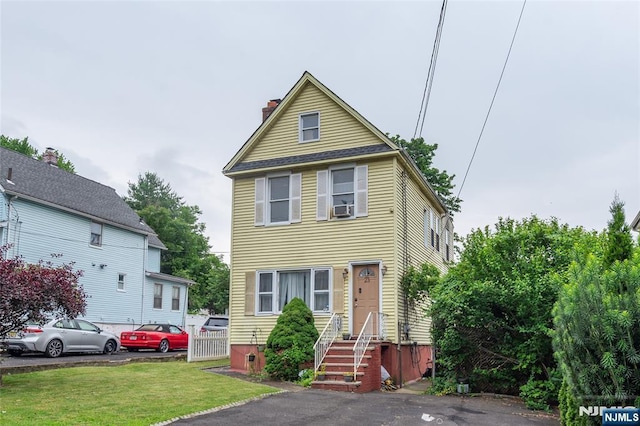 23 Preston St, Ridgefield Park, NJ 07660 - view of front of house featuring a chimney, a front lawn, and cooling unit