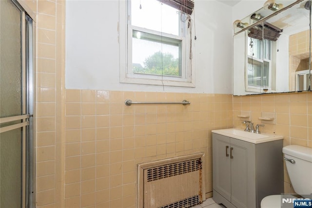 23 Preston St, Ridgefield Park, NJ 07660 - full bathroom with radiator heating unit, tile walls, vanity, a shower with door, and a wainscoted wall