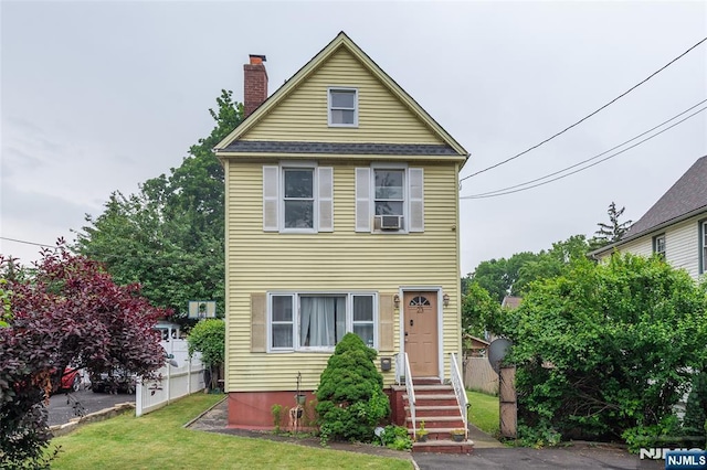 23 Preston St, Ridgefield Park, NJ 07660 - view of front of house with a chimney, a front lawn, and cooling unit