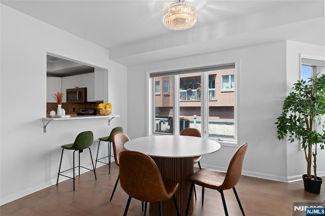 207 Jefferson Ct, Edgewater, NJ 07020 - dining room with dark wood-type flooring and a chandelier