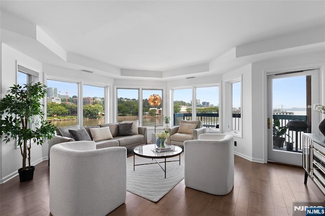 207 Jefferson Ct, Edgewater, NJ 07020 - living area with a tray ceiling, a water view, and dark wood finished floors