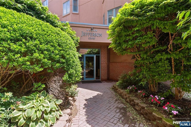207 Jefferson Ct, Edgewater, NJ 07020 - doorway to property featuring stucco siding and brick siding