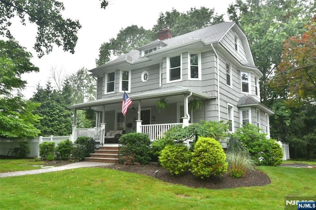4 4th St, Park Ridge, NJ 07656 - view of front of house featuring covered porch, a front yard, and a chimney