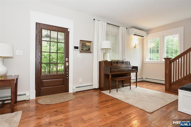 4 4th St, Park Ridge, NJ 07656 - entrance foyer featuring a wall mounted air conditioner, a baseboard radiator, stairway, and wood finished floors