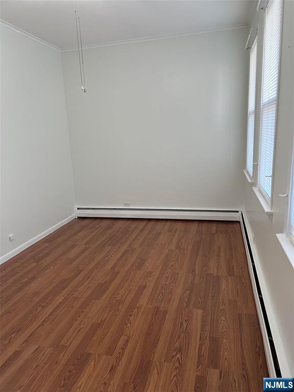 121 W 14th, Bayonne, NJ 07002 - unfurnished room featuring wood finished floors, crown molding, and baseboard heating