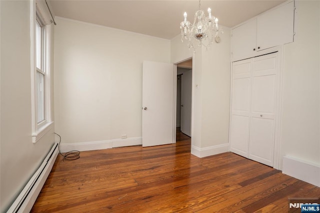 121 W 14th, Bayonne, NJ 07002 - unfurnished bedroom with a baseboard radiator, a chandelier, wood-type flooring, a closet, and multiple windows