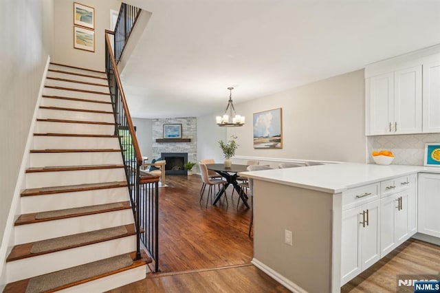181 Long Hill Rd Unit H3, Little Falls, NJ 07424 - kitchen featuring a peninsula, dark wood-style flooring, white cabinets, and tasteful backsplash