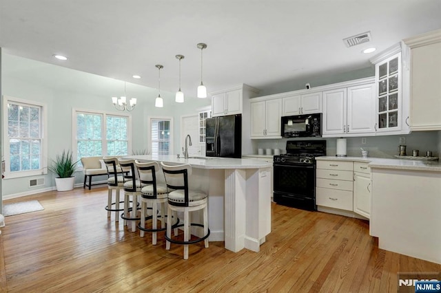 11 Katharina Pl, Twp Of Washington, NJ 07676 - kitchen with black appliances, a breakfast bar, light countertops, white cabinets, and recessed lighting