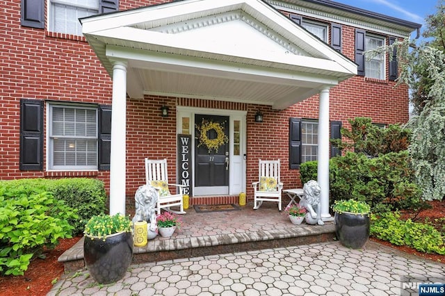 11 Katharina Pl, Twp Of Washington, NJ 07676 - view of exterior entry featuring covered porch and brick siding