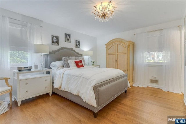 63 Kathleen Ct, Wayne, NJ 07470 - bedroom with light wood-style flooring and a chandelier