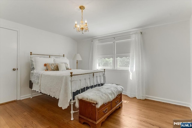 63 Kathleen Ct, Wayne, NJ 07470 - bedroom with wood finished floors and a chandelier