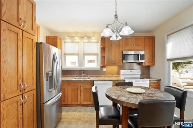 30 Zeliff Ave, Little Falls, NJ 07424 - kitchen with appliances with stainless steel finishes, a chandelier, brown cabinets, pendant lighting, and open shelves