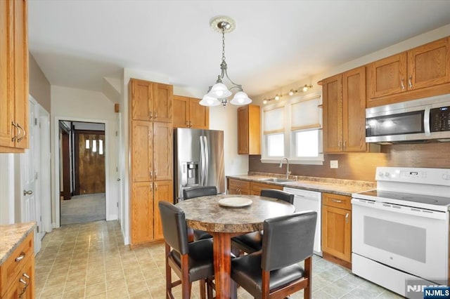 30 Zeliff Ave, Little Falls, NJ 07424 - kitchen with stainless steel appliances, decorative light fixtures, and brown cabinetry