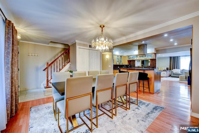 139 Donato Dr, Little Falls, NJ 07424 - dining room featuring a chandelier, stairway, ornamental molding, and light wood-type flooring