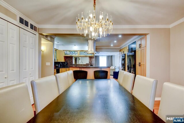 139 Donato Dr, Little Falls, NJ 07424 - dining room with ornamental molding and a chandelier
