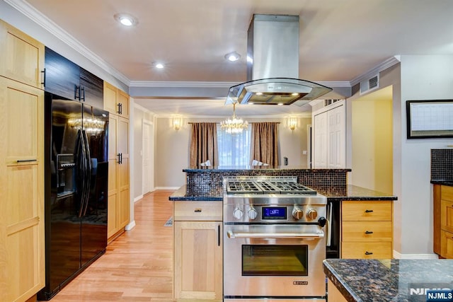 139 Donato Dr, Little Falls, NJ 07424 - kitchen with stainless steel range, black fridge, island range hood, ornamental molding, and a chandelier