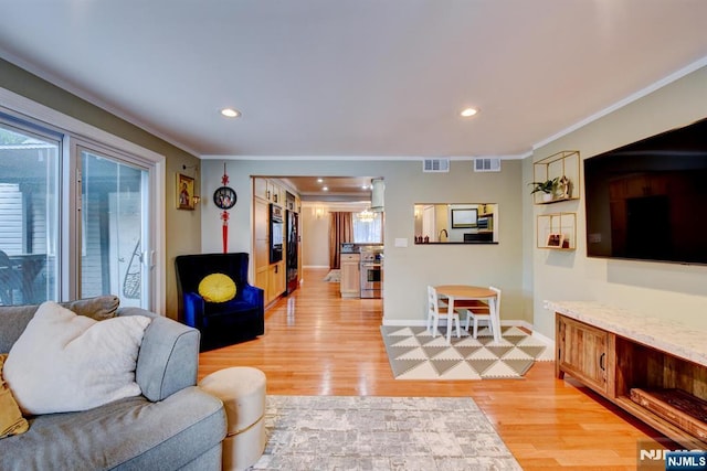 139 Donato Dr, Little Falls, NJ 07424 - living room featuring healthy amount of natural light, ornamental molding, light wood-type flooring, and recessed lighting