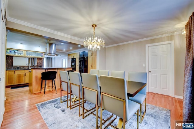 139 Donato Dr, Little Falls, NJ 07424 - dining area with a chandelier, light wood-style floors, and crown molding