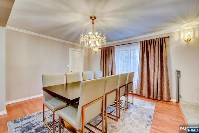 139 Donato Dr, Little Falls, NJ 07424 - dining space featuring a chandelier, wood finished floors, and ornamental molding