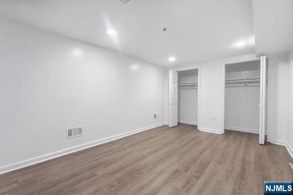 2608 Kennedy Blvd Unit 1, Union City, NJ 07087 - unfurnished bedroom with two closets, wood finished floors, and recessed lighting