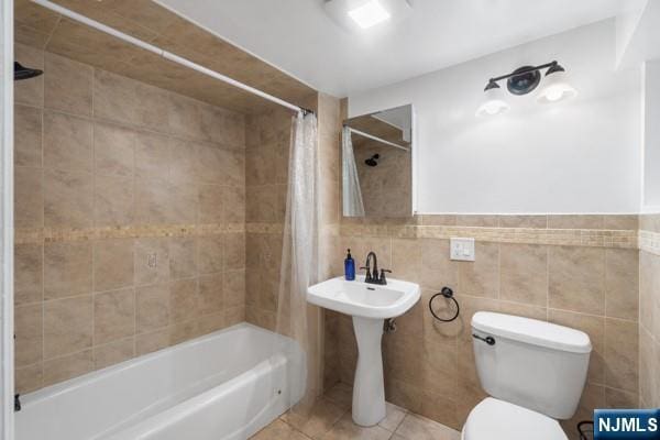 2608 Kennedy Blvd Unit 1, Union City, NJ 07087 - full bath featuring shower / bathtub combination with curtain, tile walls, and tile patterned flooring
