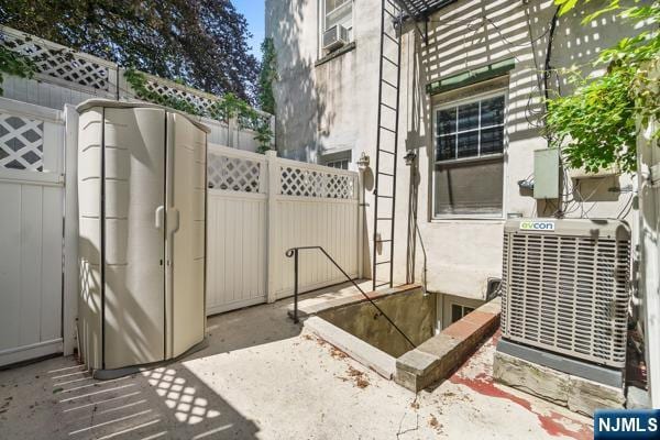 2608 Kennedy Blvd Unit 1, Union City, NJ 07087 - view of patio featuring cooling unit and a gate