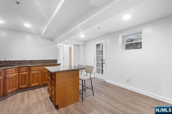 2608 Kennedy Blvd Unit 1, Union City, NJ 07087 - kitchen with a kitchen breakfast bar, light wood-style floors, brown cabinets, a center island, and recessed lighting